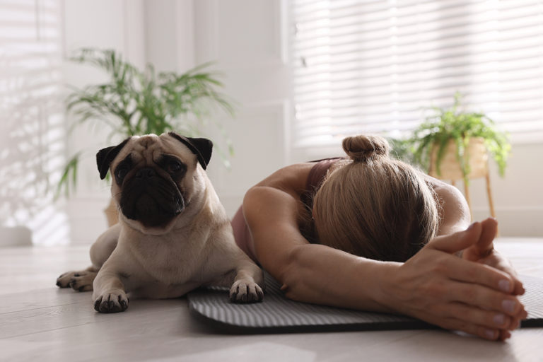woman and dog doing yoga